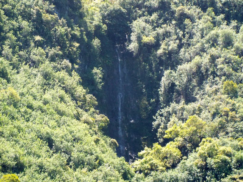 Zooming in on a gorgeous waterfall dropping down the high cliffs.  The Kalaupapa peninsula no doubt has many secret spots of great beauty: