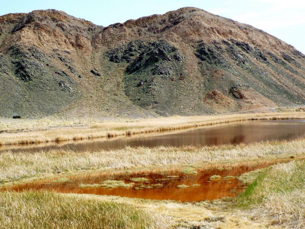 The smaller reddish pond in the foreground is shallow and likely contains abundant pupfish:
