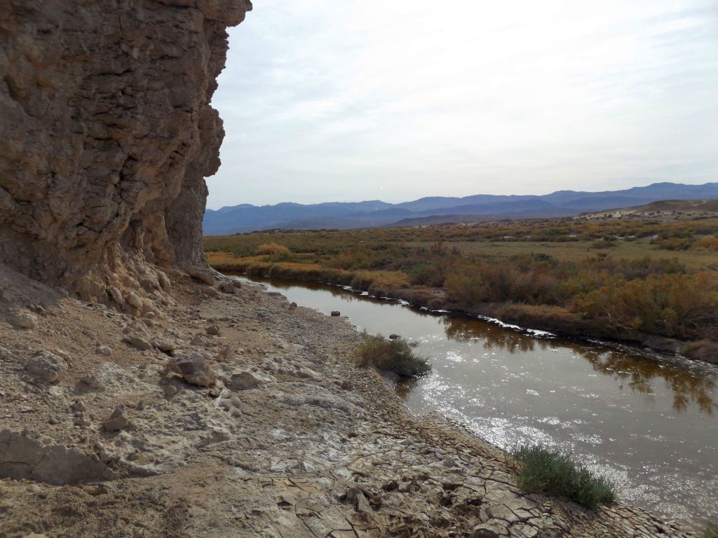 Tall rocky cliffs rose up on the left side of the riverbank: