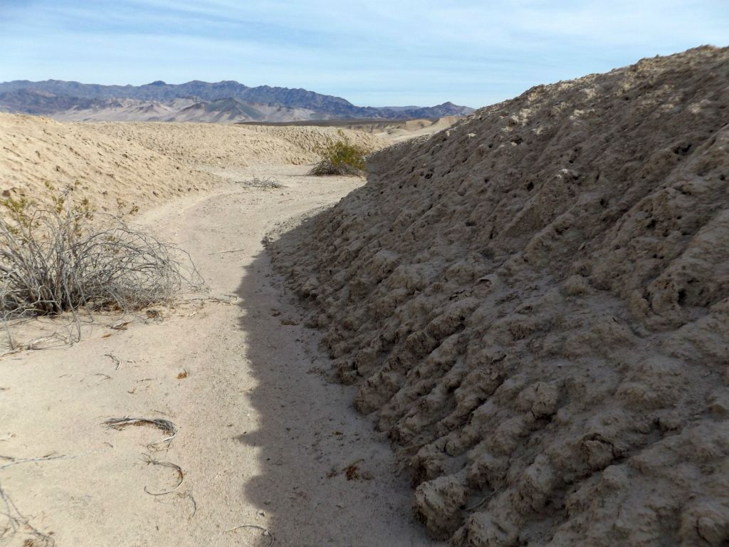 The wash soon becomes entrenched with soft mud walls on each side: