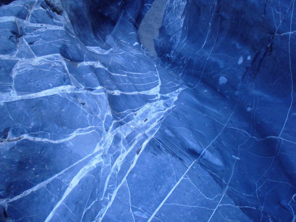 A close-up of this final passage with the beautiful blue canyon floor and white streaks.  Note how much the lighting can change the color as you compare this to the previous photo: