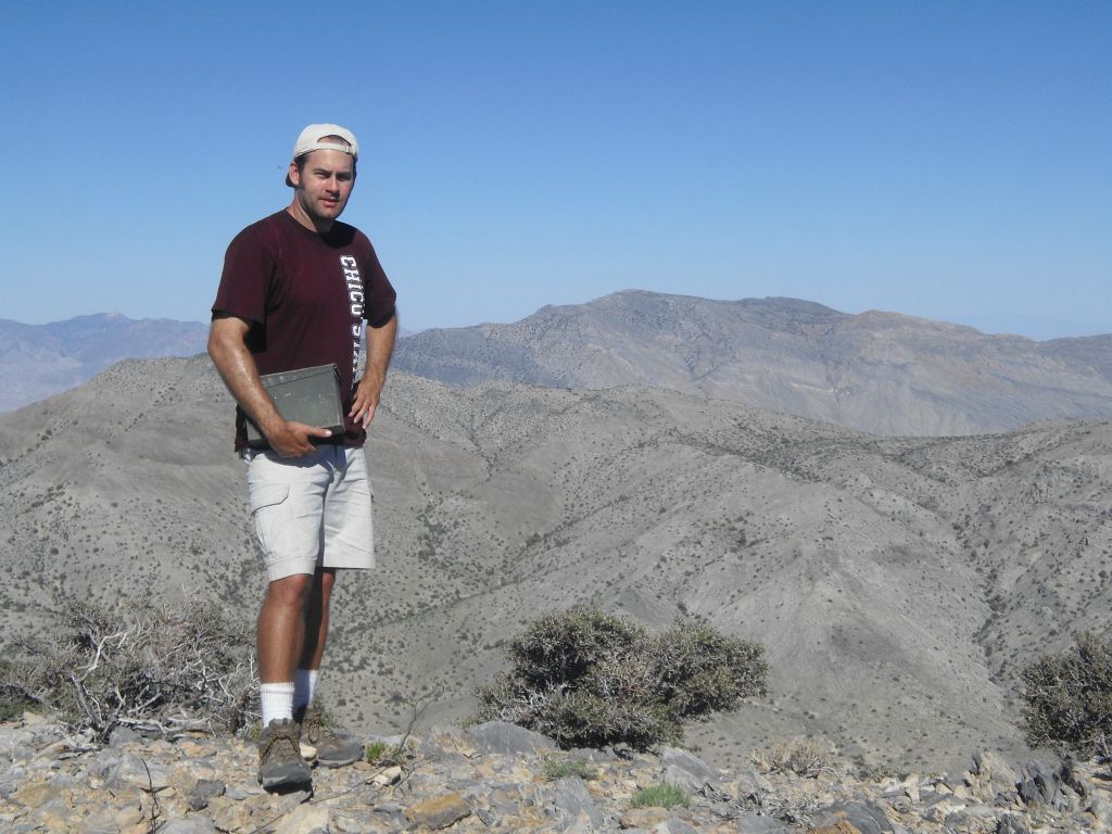 And one last picture of Steve with the summit register and Tin Mountain in the background: