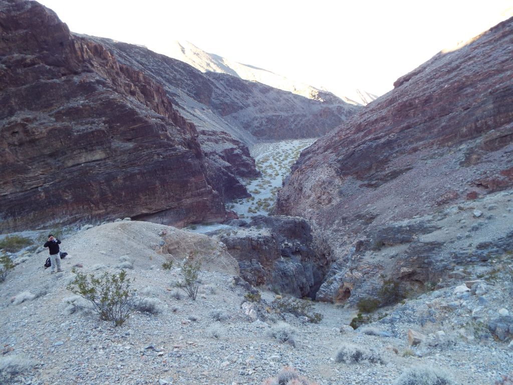 Mel is standing in the middle of the spur trail close to the start of it.  To the right, you can see the small side canyon with narrows that dead-ends at a dry fall reported on in my Grand View Canyon report: