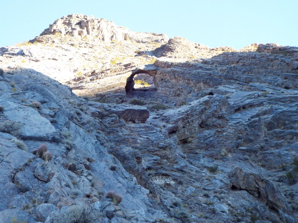 The trail next passes to the left of a cliffs area.  There are good views through here of the arch:
