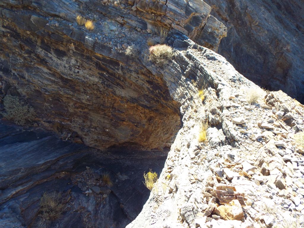 I wouldn't recommend trying to walk across the top of the arch.  The rock looks a bit unstable: