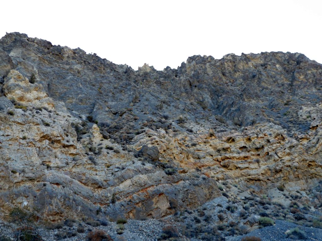 The tan and red bottom half appeared to have lots of small caves, while the darker upper half had a very sharp and distinct top ridge: