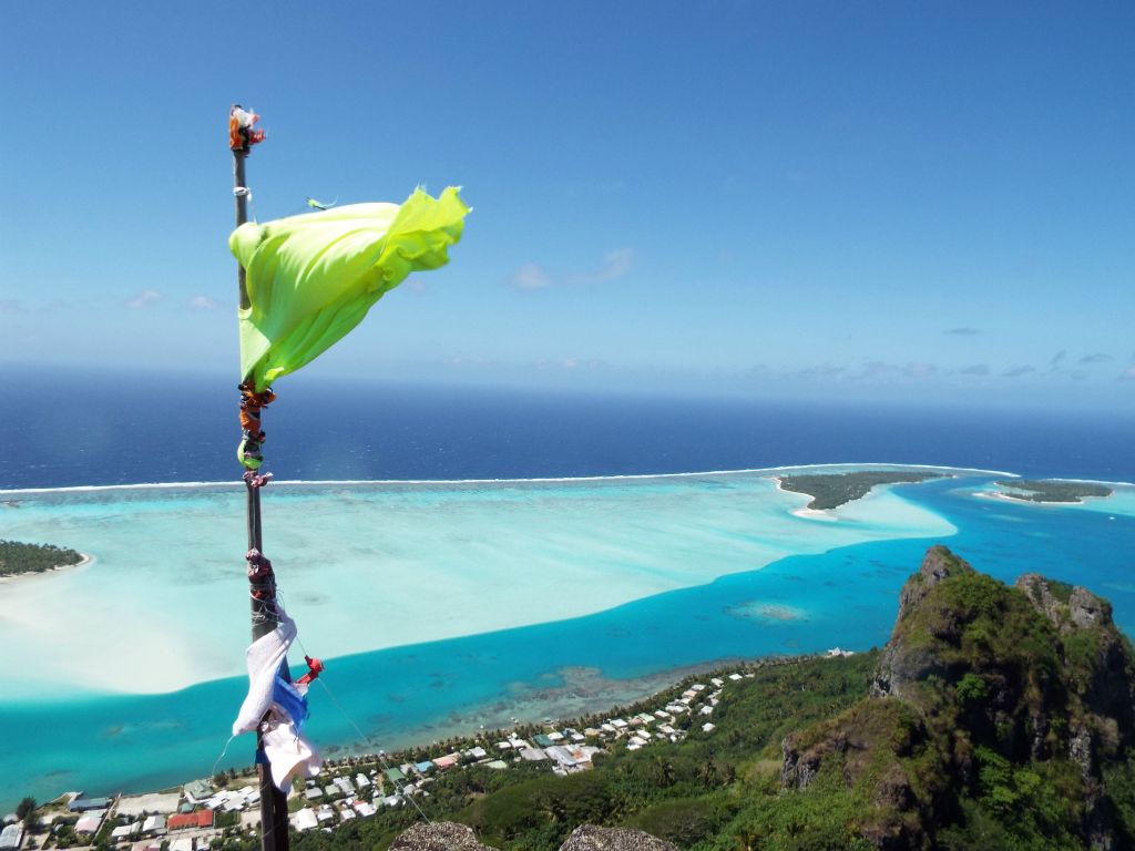 This flagpole on the summit looks like it regularly has makeshift flags added to it until the wind shreds them: