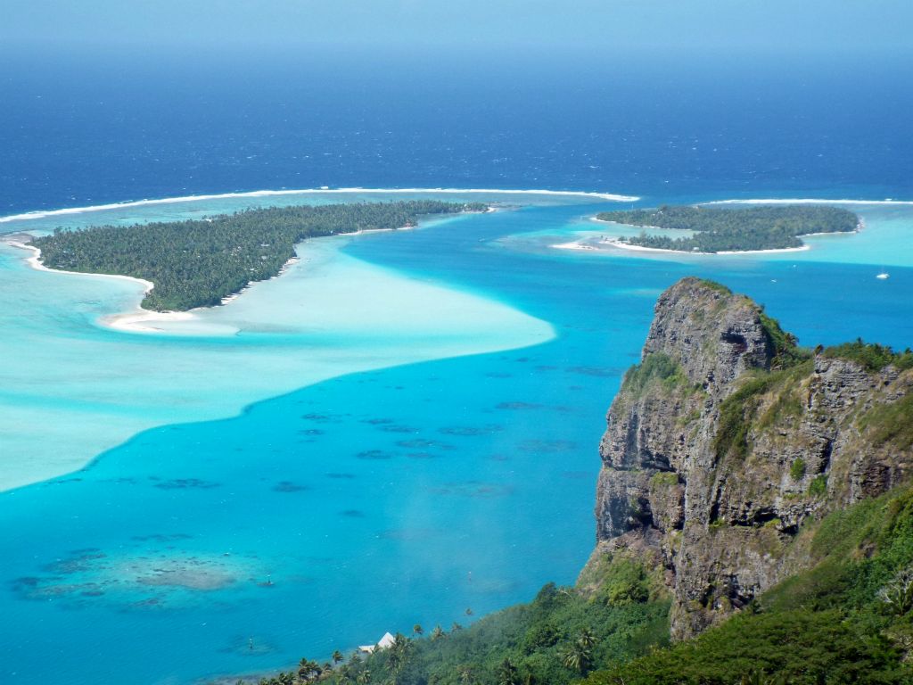Mt. Hotu Paraoa pictured with Onoiau Pass behind it.  Onoiau Pass is the pass between the lagoon and ocean which is used by boats traveling to and from Maupiti: