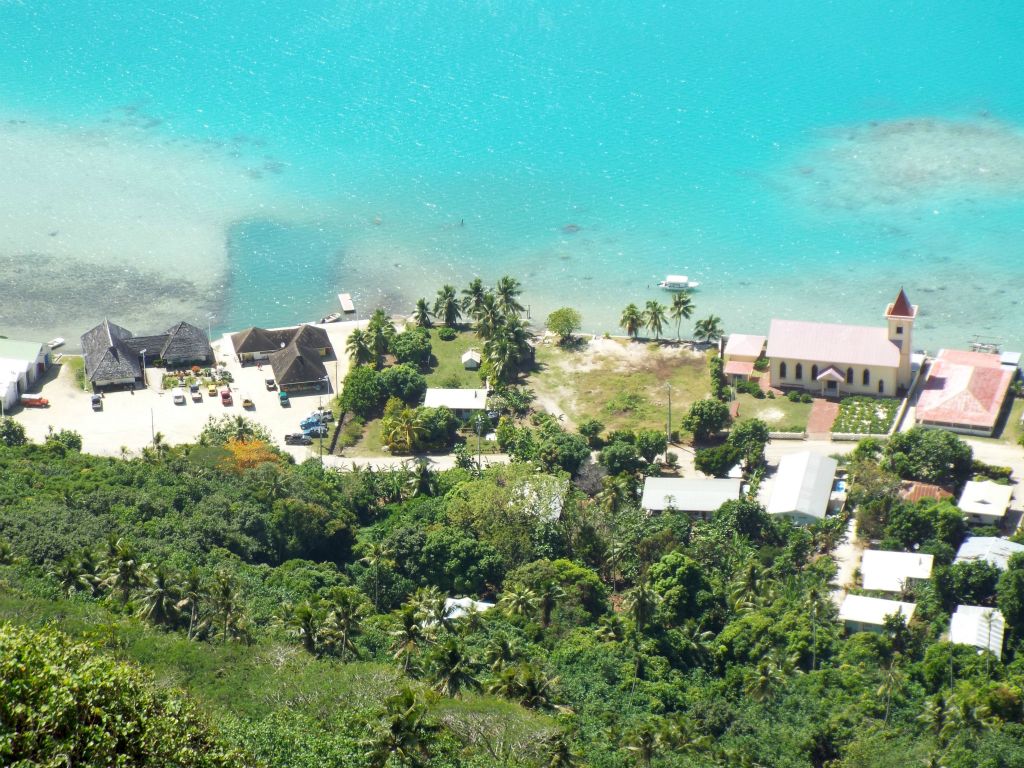 A clear view looking down at Vaiea showing the main dock and colorful church building: