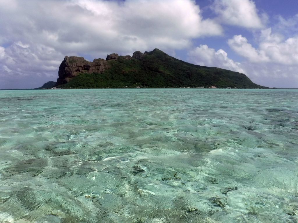 A nice picture showing Mt. Hotu Paraoa (left sheer cliff) and Mt. Teurafaatiu (just left of the center high point) as seen from the lagoon: