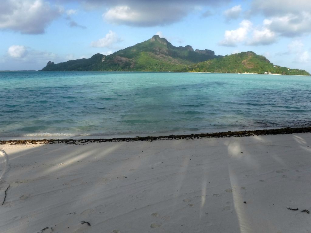 Mt. Teurafaatiu (just right of center high point) as seen from a beach on Motu Auira:
