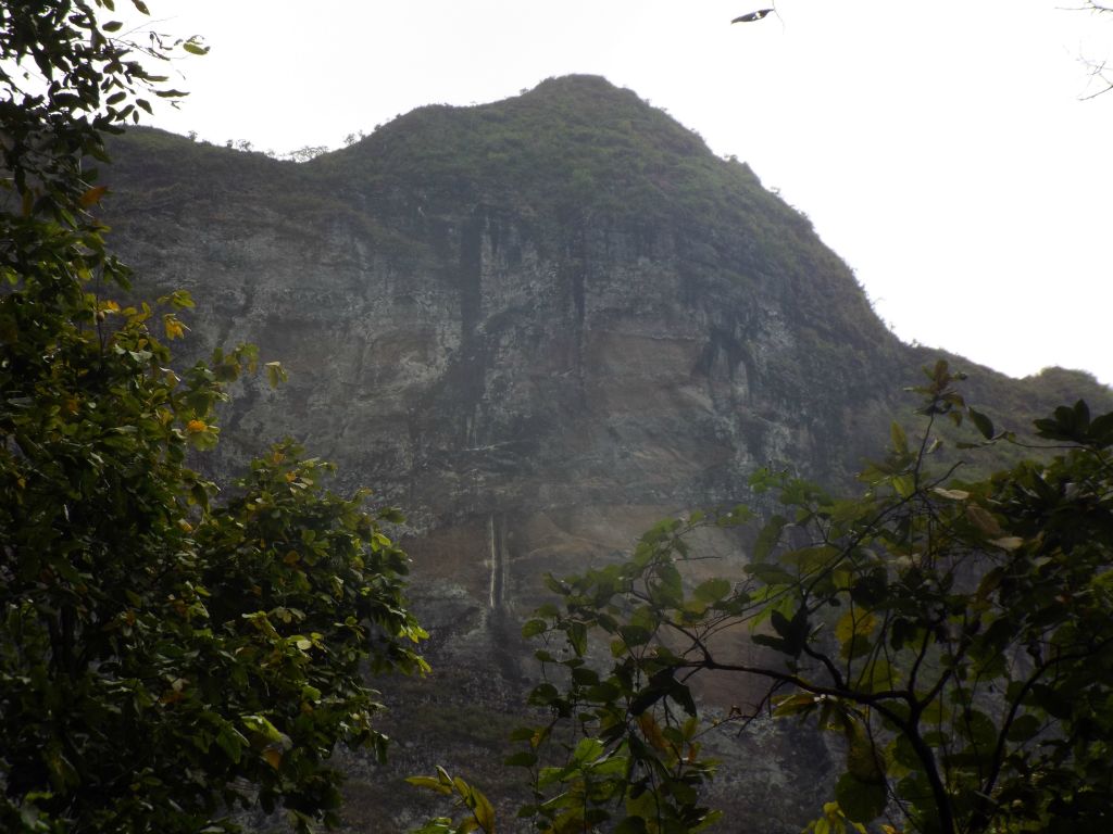 The sheer rock walls of this mountain became visible through the brush: