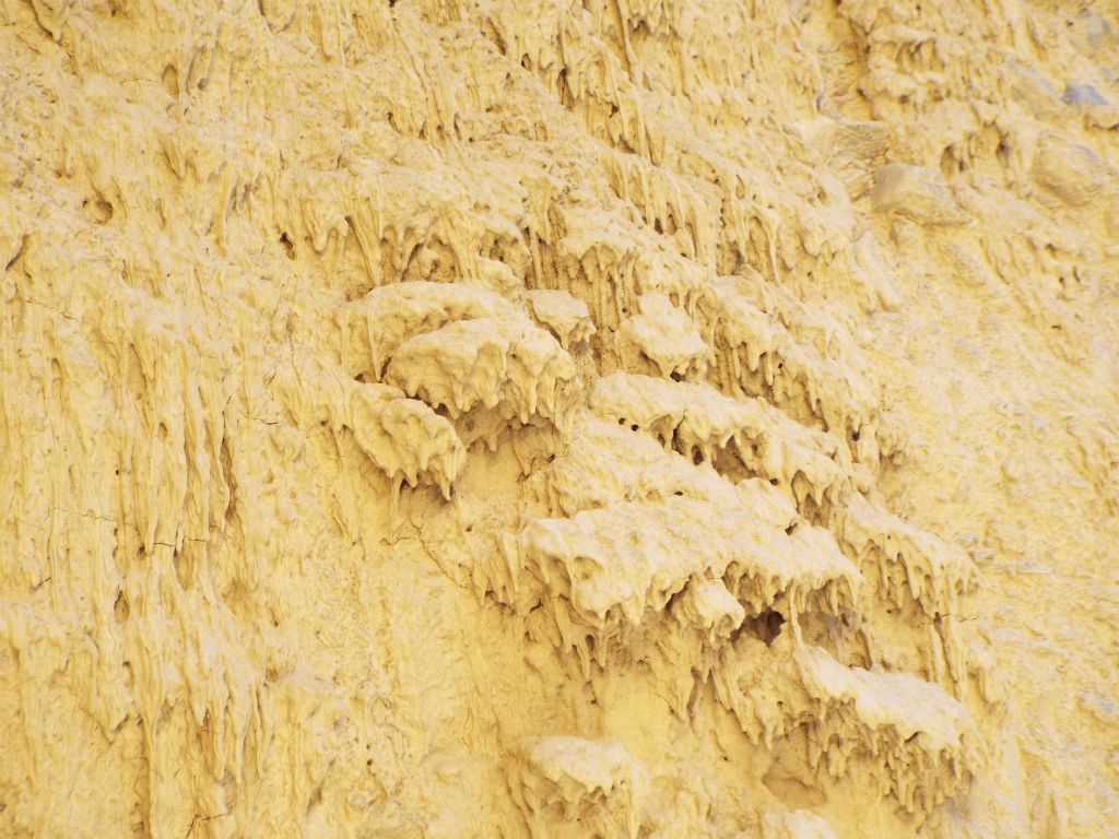 Some of the mud drips are long and some are short.  Some also have formed piles of mud drips: