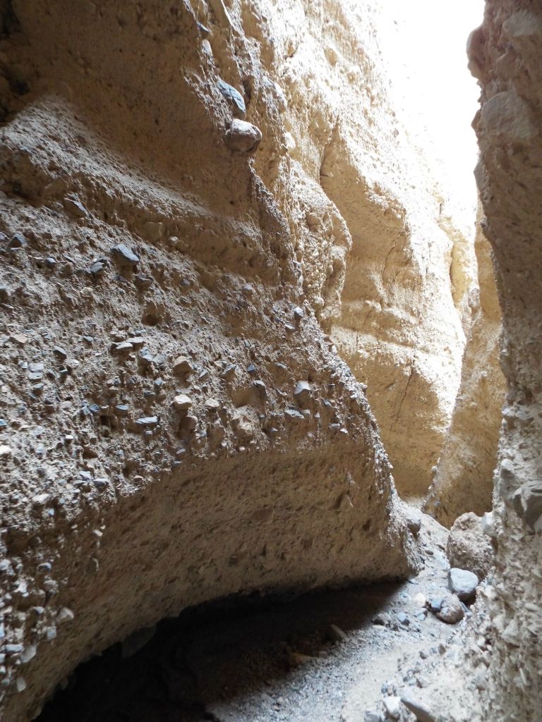 Shadows and glows on the conglomerate rock slot walls: