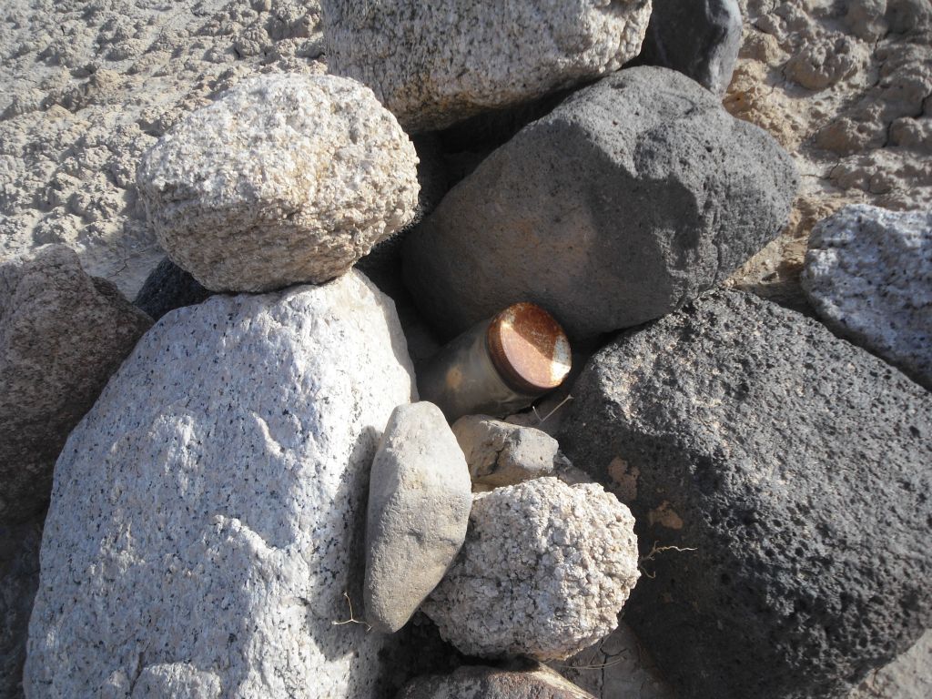 We found this old bottle which contained a crumbling mining claim form inside: