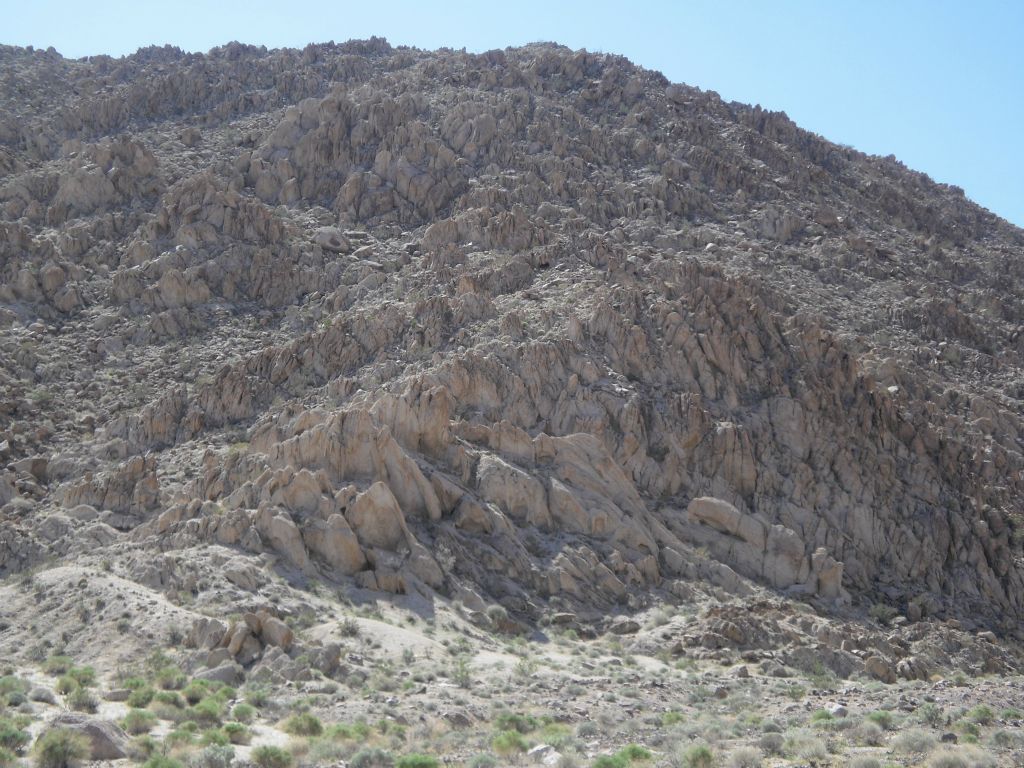 A hillside completely covered by unique decomposed granite Owlshead rock and boulders: