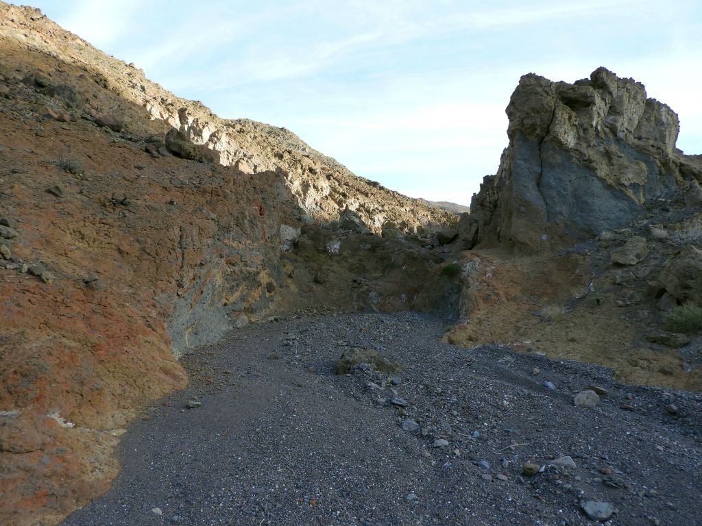 More contrasting colors on both sides of the canyon, with red on the left and blue rising above on the right: