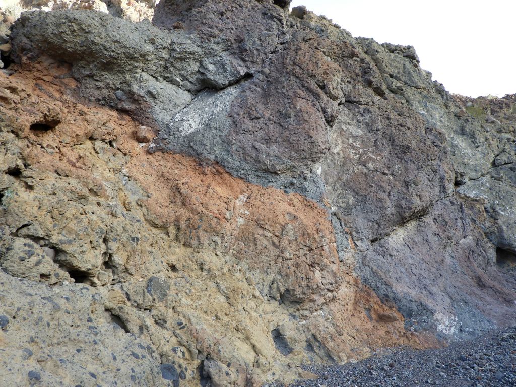 A dramatic shift in colors from yellow to orange to purple in a short span of rock:
