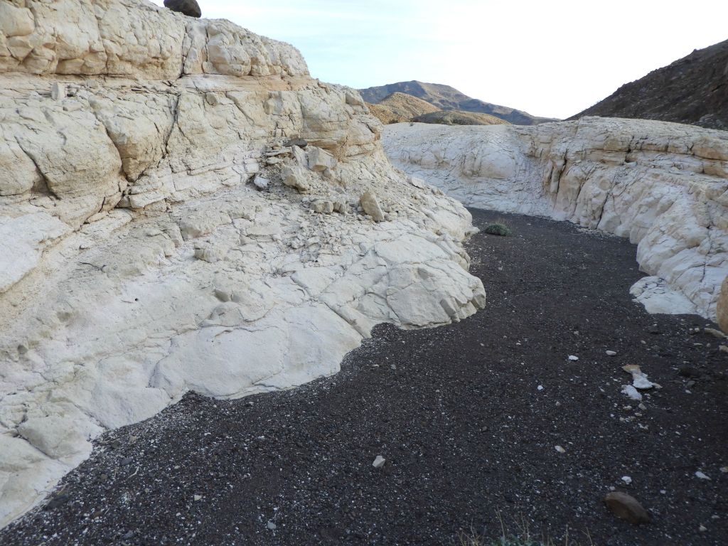 The white narrows (perhaps some type of volcanic ash deposit) really stand out against the backdrop of the black wash flowing down the middle: