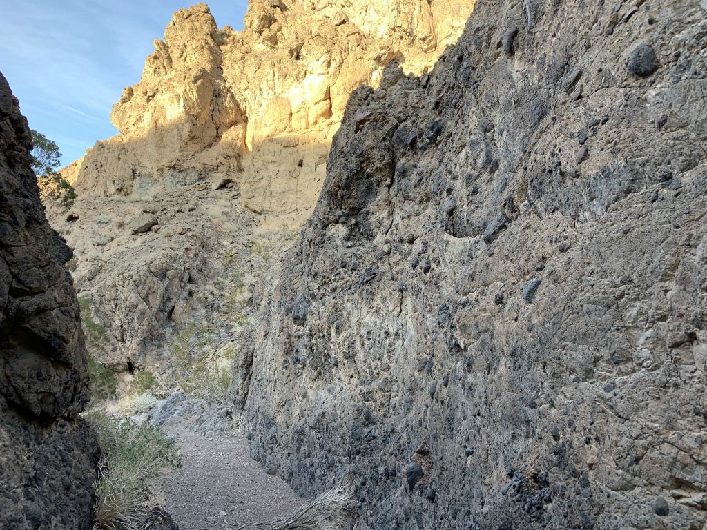 Looking back at the long flat wall which stretches back toward the golden cliffs: