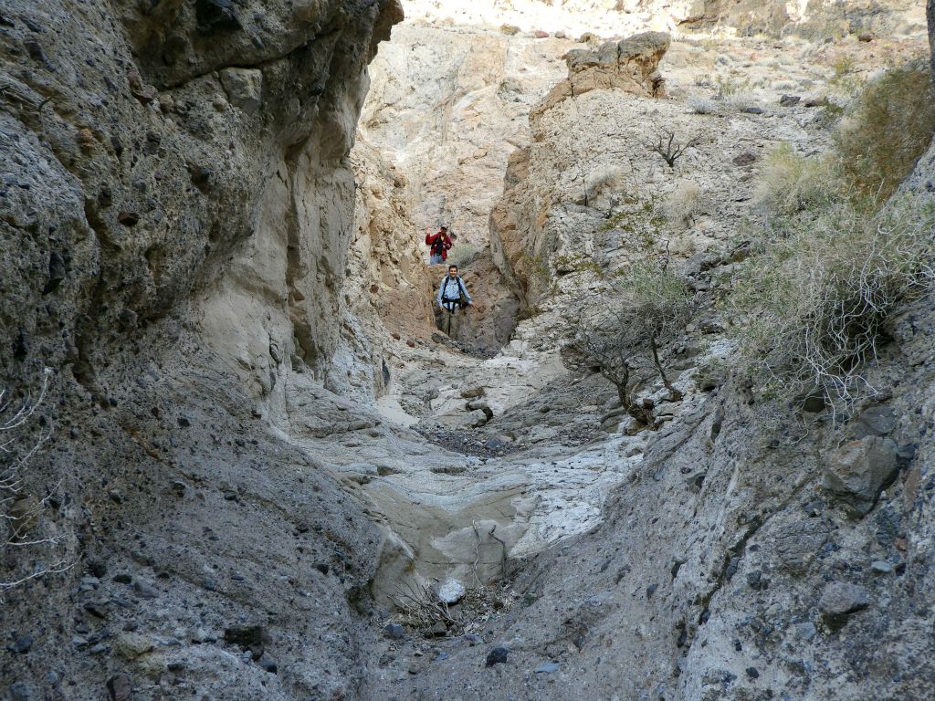 Passing through a fun enclosed area where the rock walls extend down and solid rock covers the canyon floor: