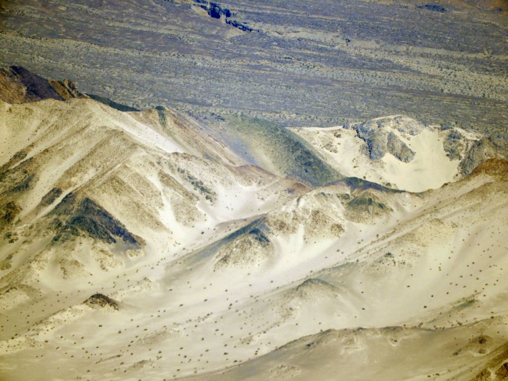 Behind the dry lake bed, Summit Dune, the highest recognized point of the Buckwheat Sand Dunes, can be seen: