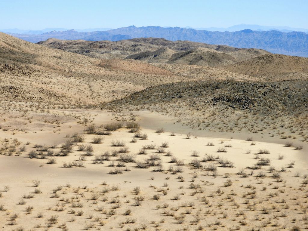 The hidden dry lake soon comes into view from above: