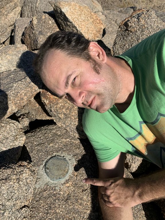Getting a close-up picture with the benchmark.  If I remember right, I started this tradition on the summit of Con BM some 8 1/2 years earlier: