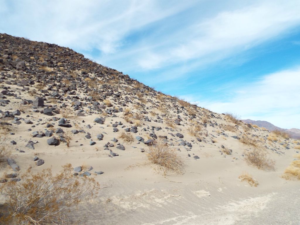 The hillside had a lot of sand on it, especially near the base: