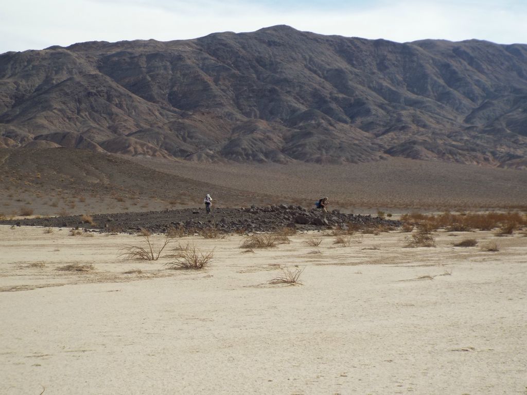Tobin and Debbie gathering their backpacks and heading down onto the lake bed: