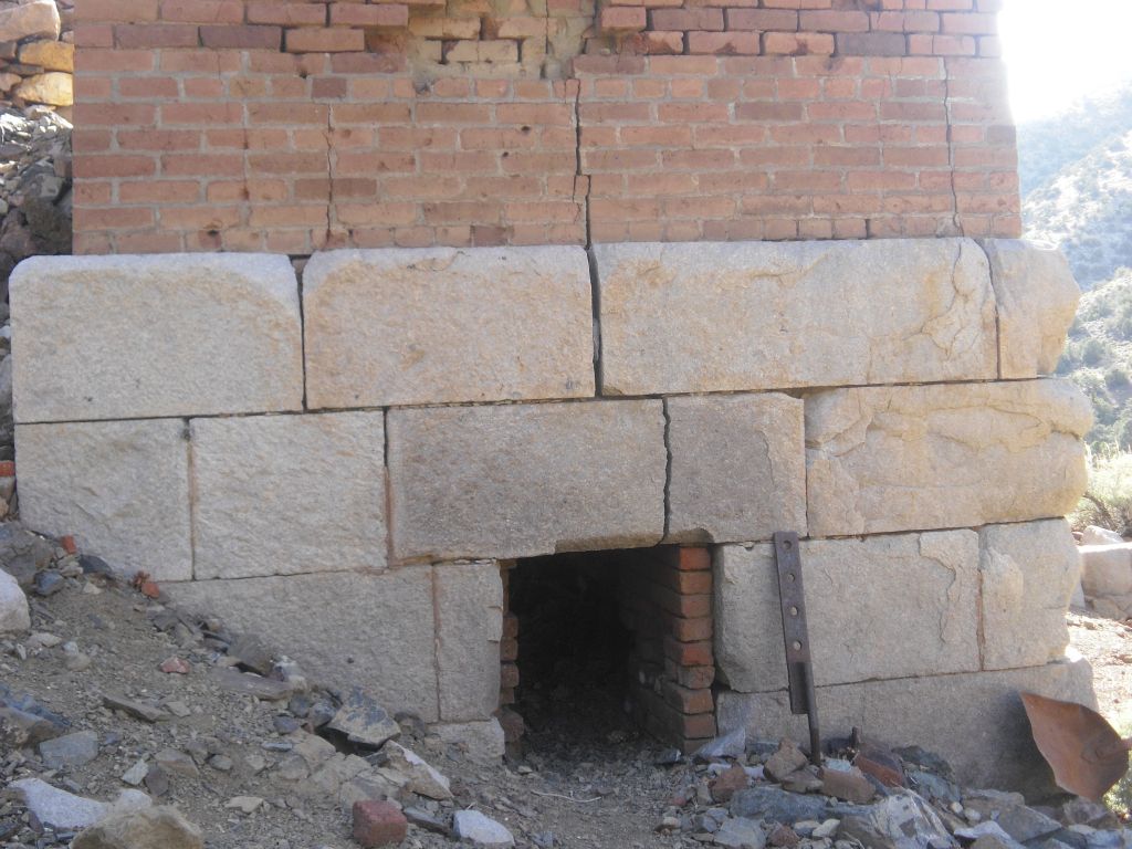 A few shots showing the blocks of stone around the base and nearby foundation and retaining wall: