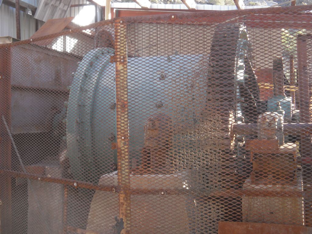 Large gears and machinery behind this fenced-off area: