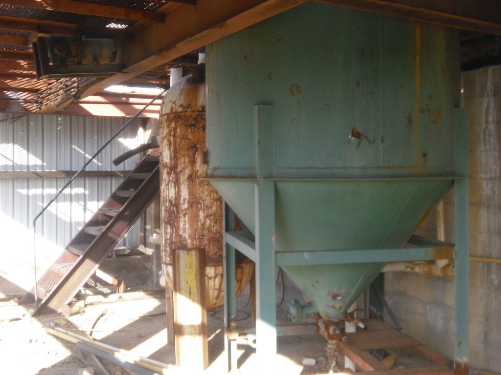 A large green cylinder is partly in both the lower and upper rooms: