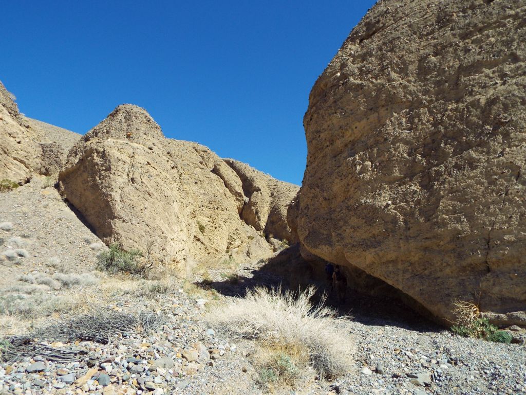 As the day began heating up, we continued up canyon.  Notice here how the guys are hiking in the shade of the undercut: