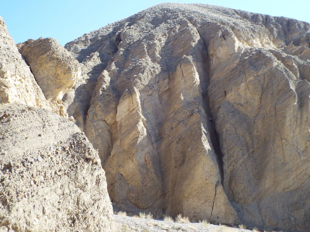 Near this area of high cliffs, we checked out another potential slot which did not pan out.  But we did get to enjoy the sight of an owl taking flight out of the small side canyon which cuts to the left: