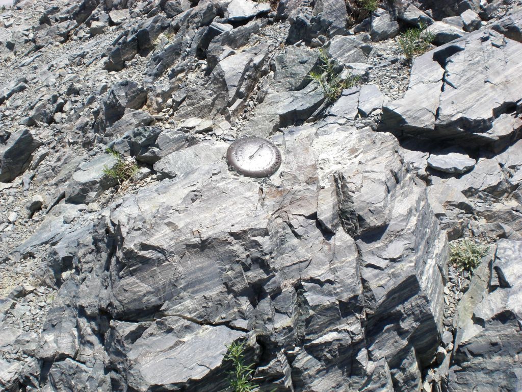 Two pictures of the benchmark survey marker at the top: