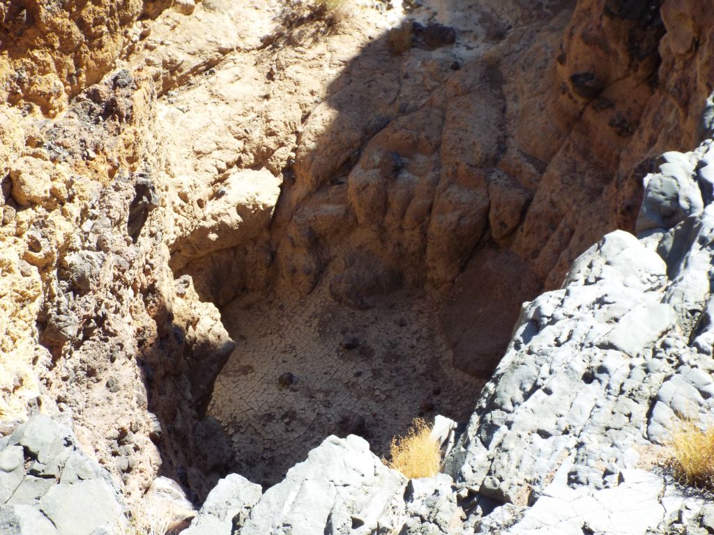 First view looking down into the deep, dry plunge pool: