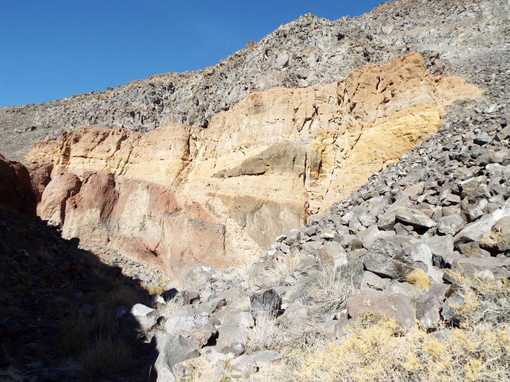 More colorful layers stand out in the midst of being surrounded by boulders: