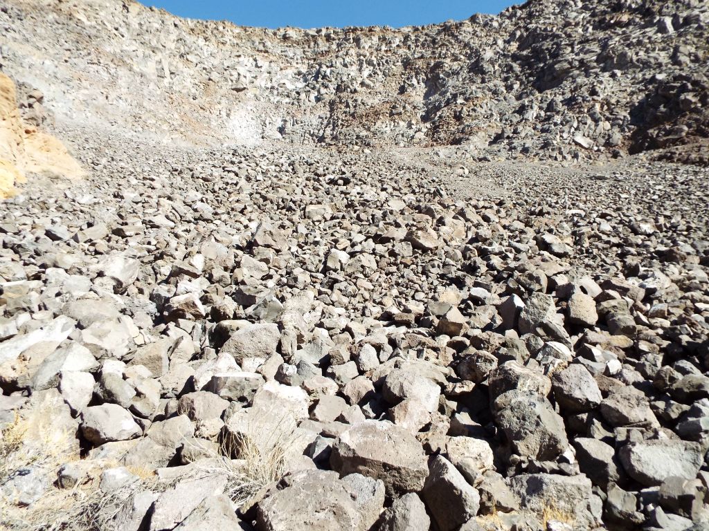 A boulder basin with a landslide of rocks coming all the way down the hillside: