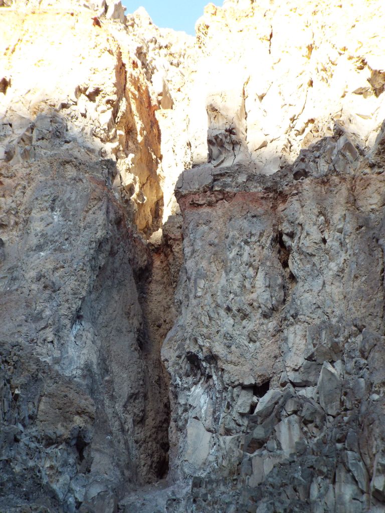 A short slot in the canyon wall which had multiple high dry falls: