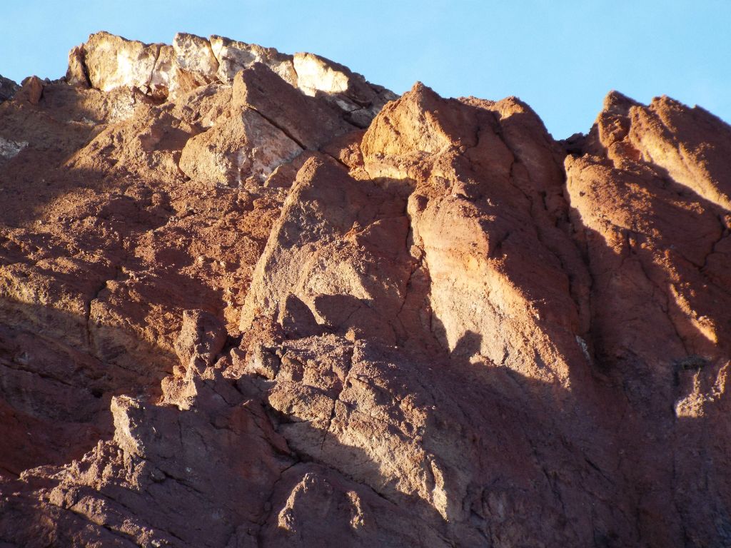 A white substance was covering these red rocks higher up:
