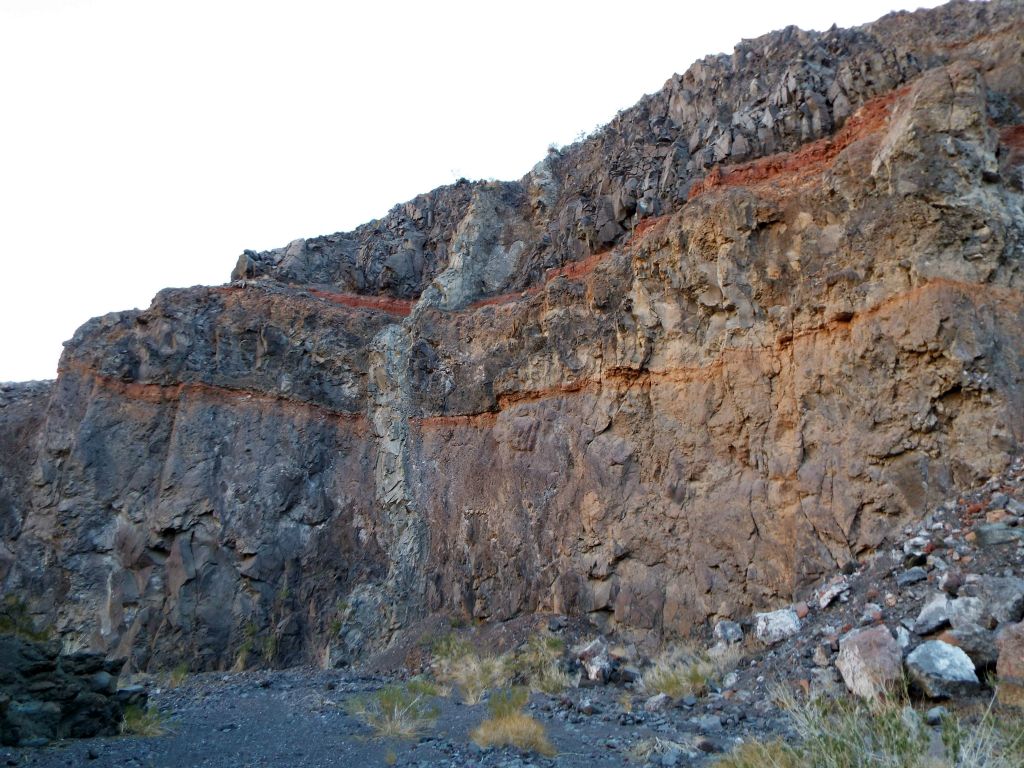 A vertical rock vein cuts through the horizontal layers: