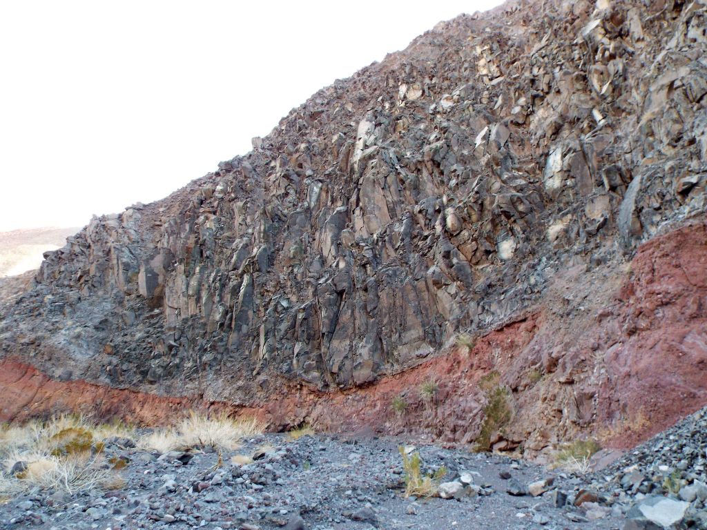 Notice how the red rock layer at the bottom is tilted and gets larger on each end: