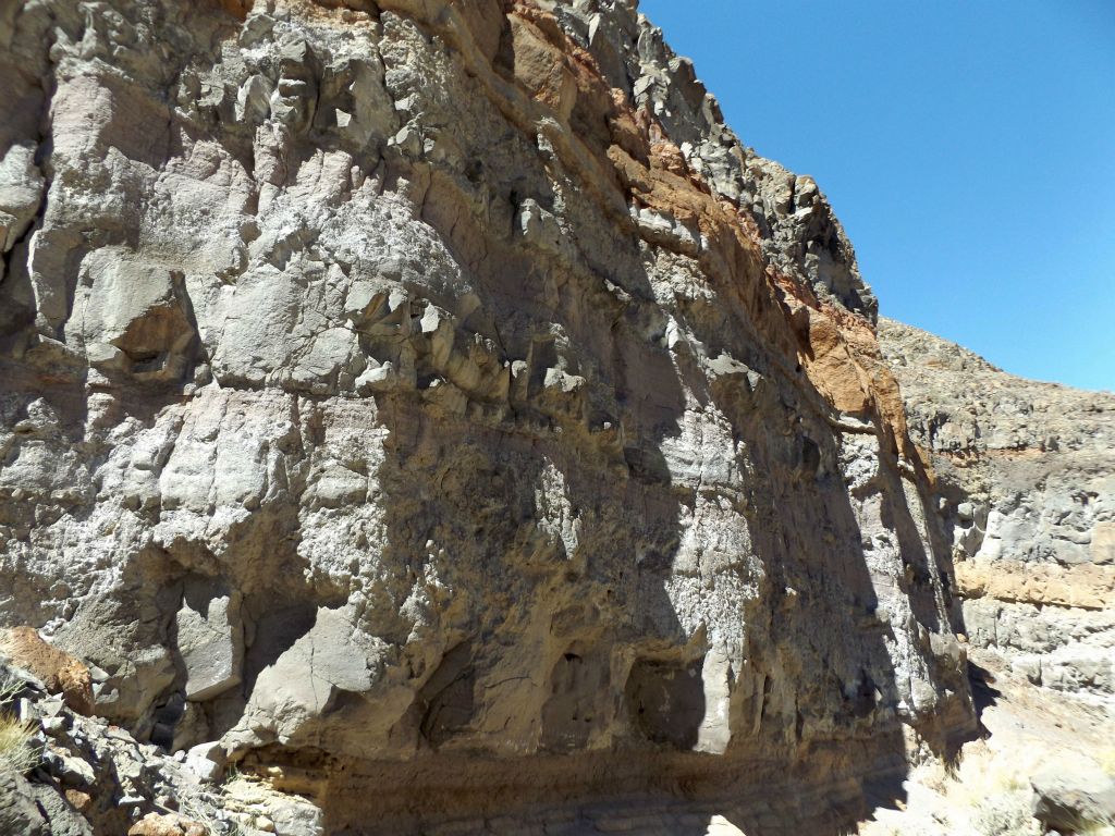 Orange, purple, and pink bands of color mixed in with various types of rock: