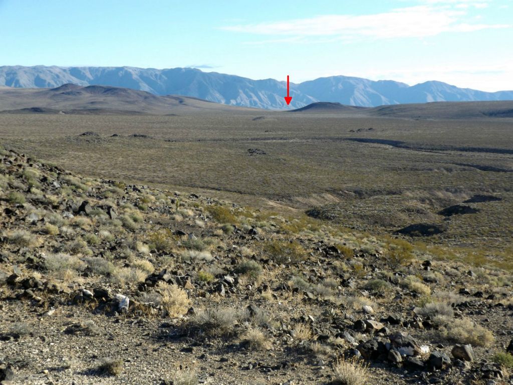 The aim spot to hike toward from the starting point is the left side of this round hill seen far in the distance: