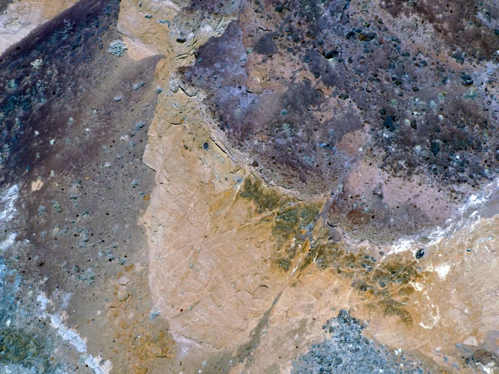 A mixture of solid rock and dirt hillsides, all covered with a variety of colors: