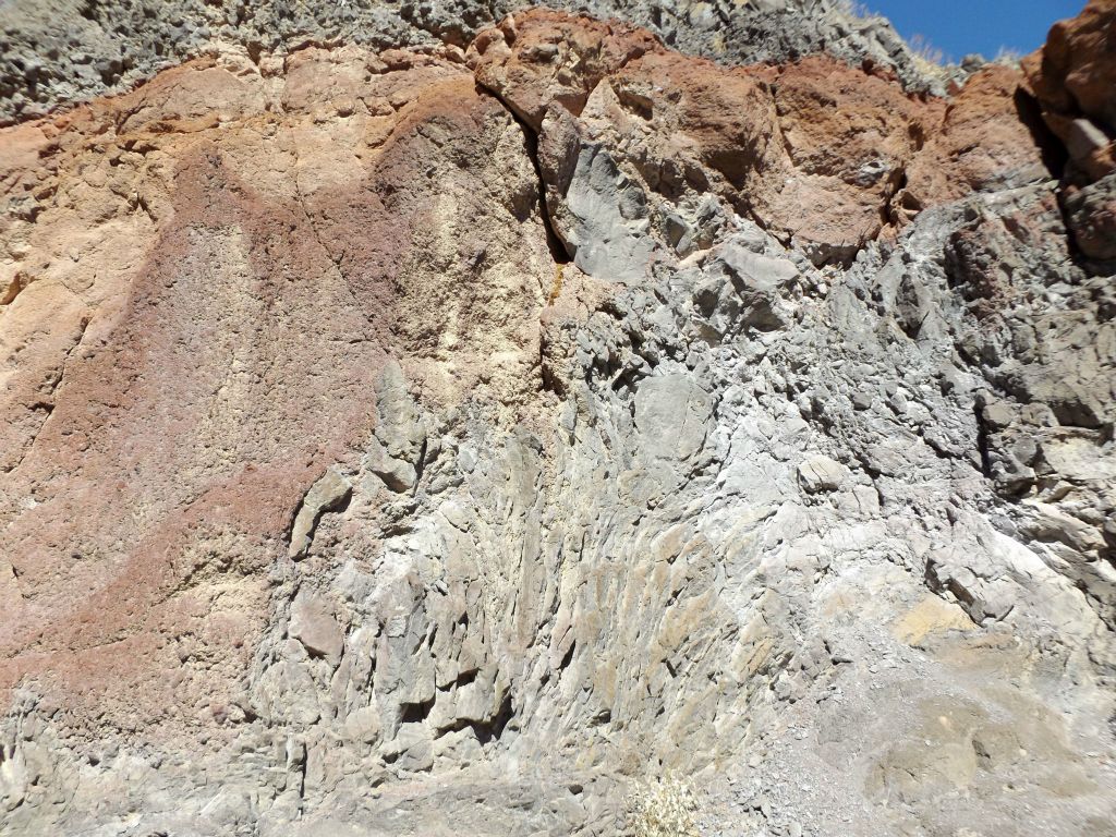 A smaller canyon wall with a mixture of orange, red, and gray colors: