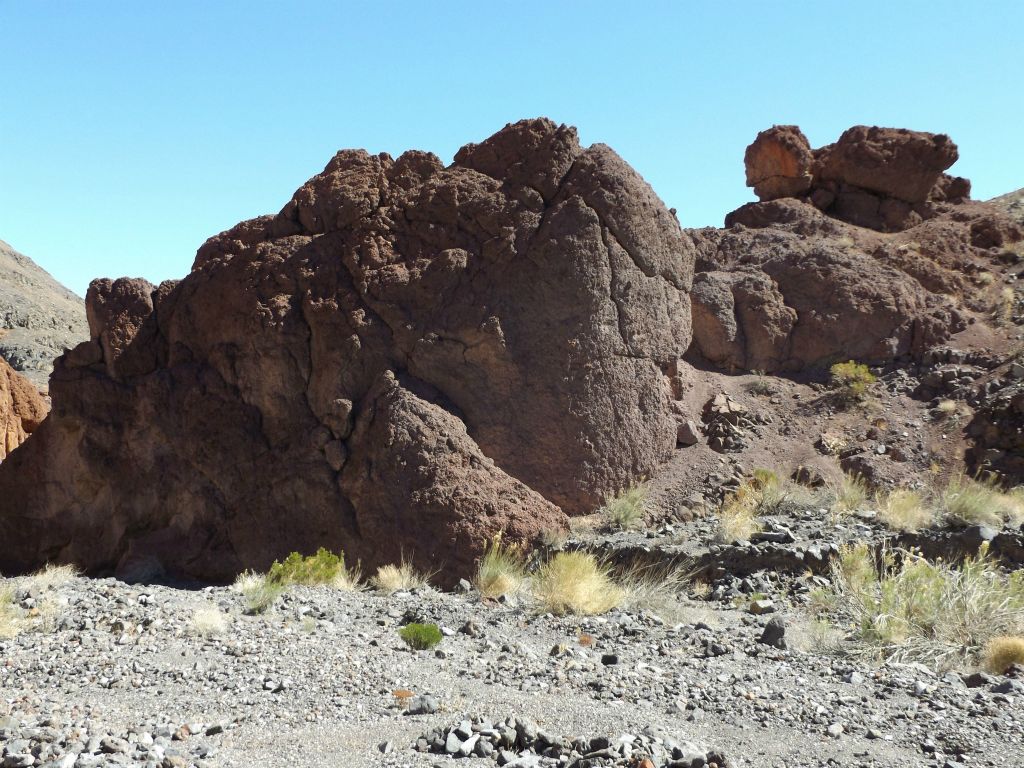Dark red rock outcroppings on the right side of the canyon: