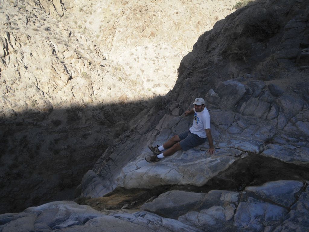 And two pictures of Steve resting and looking over the drop.  Thinking back, I probably should have stayed a few more feet back from the edge: