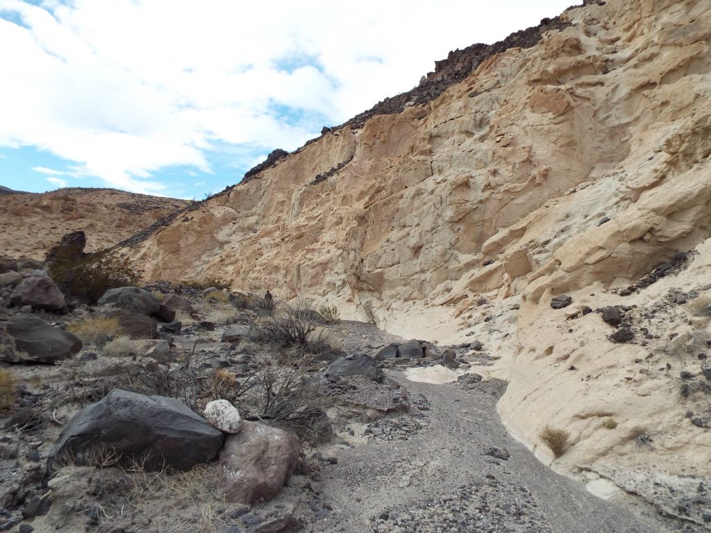 The dark hillsides gradually give way to lighter colors: